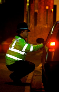 Policeman checking a vehicle