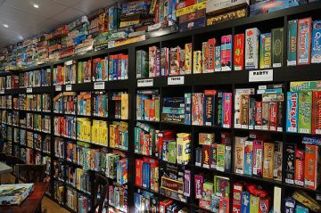Lots of board games stacked on shelves