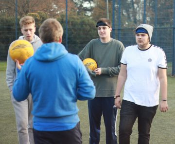 This is a photo of some Bournemouth University students being coached by Hampshire FA's Michael Conway. The students were taking part in a blind football taster session.