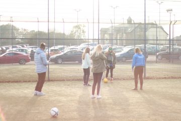 This is a photo of some Bournemouth University students taking part in a blind football taster session.