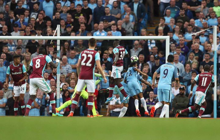 Antonio heads the football for West Ham at Manchester City