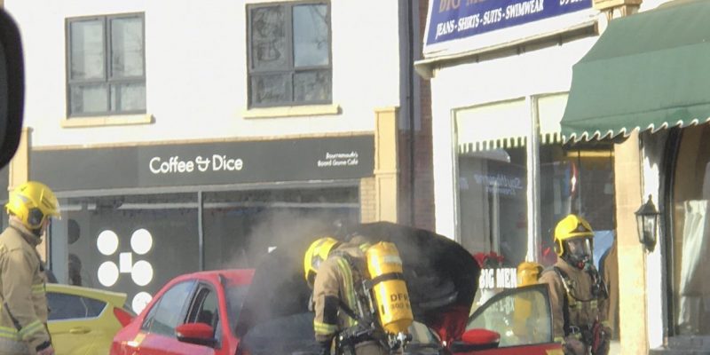 A taxi fire being dealt with by firefighters
