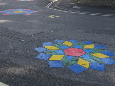 Photo of colourful road art of flower