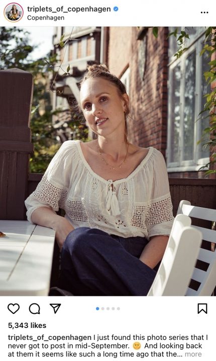 Maria Jørstad smiling and looking at the camera whilst sat at a cafe table.