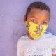 Child stood with bandana over face
