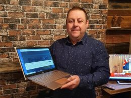 Sean Clayton, mayor of Ashbourne and founder of Laptops for Learners, holding a donated computer.
