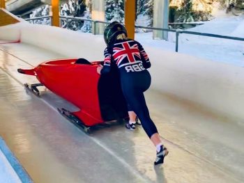 Photo of Rebecca Hannibal pushing a bobsleigh.