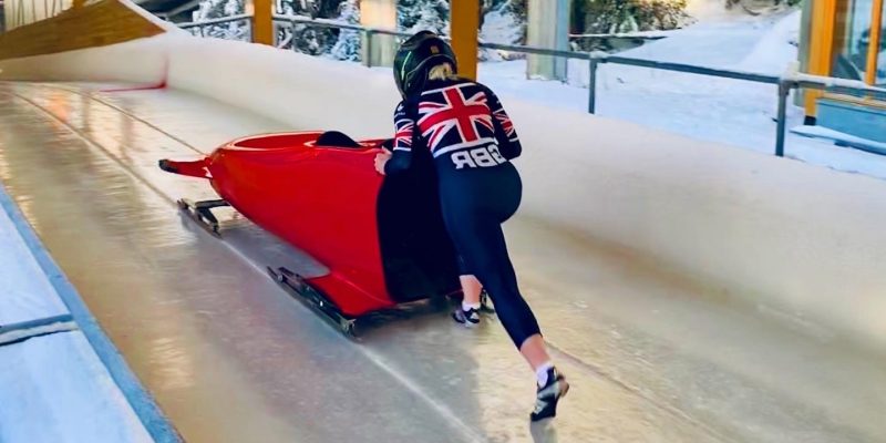 Photo of Rebecca Hannibal pushing a bobsleigh.