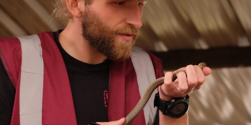 A man holding a snake.