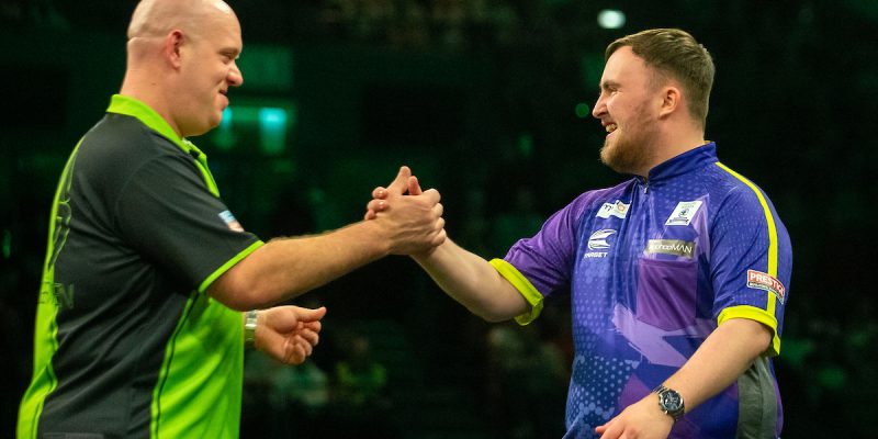 Michael van Gerwen and Luke Littler locking hands in last year's Premier League.