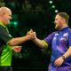 Michael van Gerwen and Luke Littler locking hands in last year's Premier League.