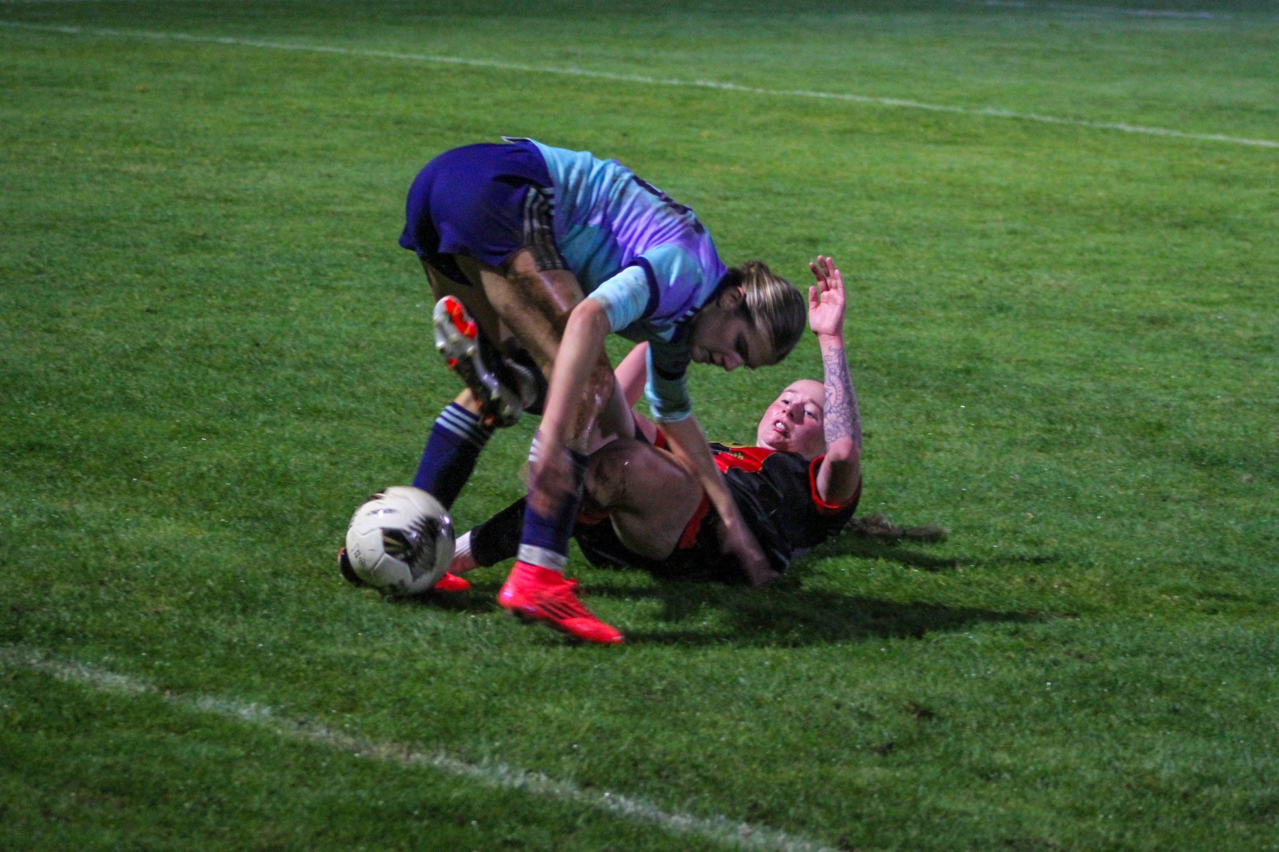 Erin Bloomfield slide tackling an Arsenal u21s player