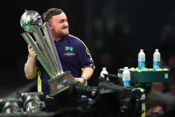 Luke Littler lifting the Sid Waddell trophy after his World Championship triumph.