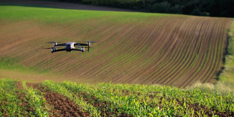 photo of drone over green field