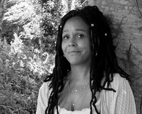 Black and white picture of Louise Adoja Parker in front of a tree.