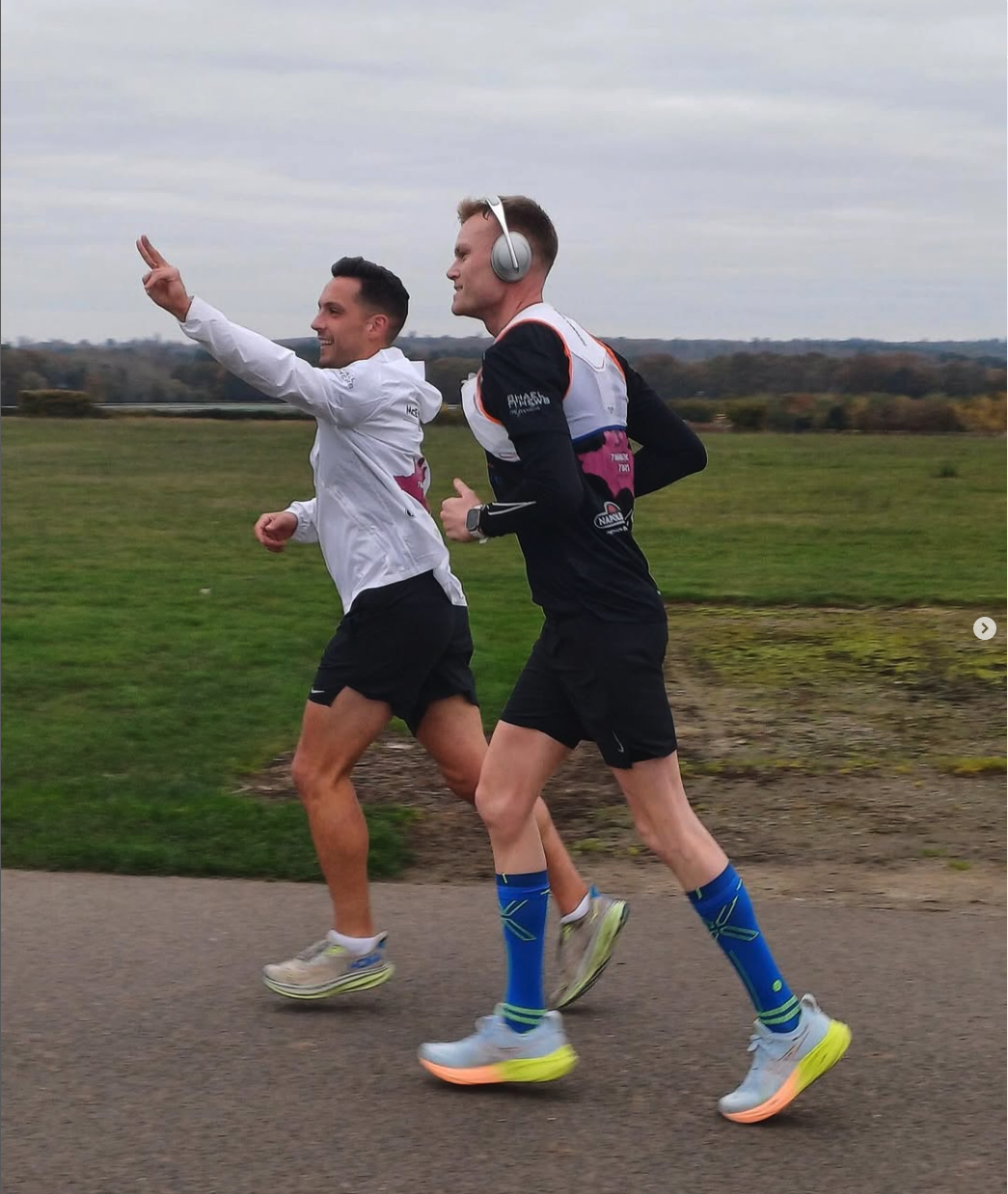 two men running in a park training marathon