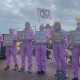 Extinction Rebellion stood holding placards outdoors.