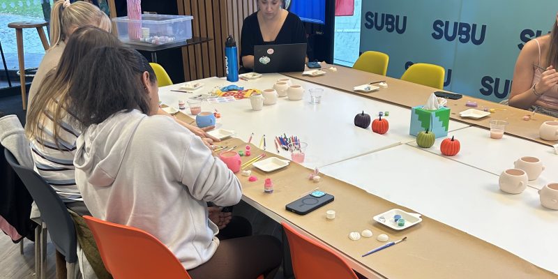 Students decorating mugs