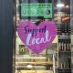 Sign that says "support local" on a bakery window