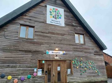 outside of The Treehouse, a alarge wooden building