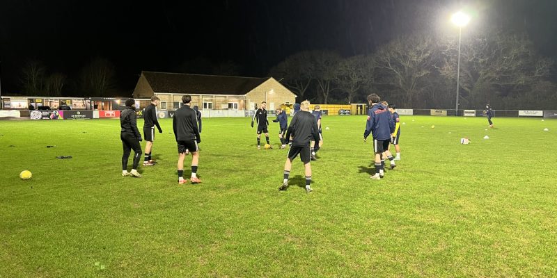 Bashley player warming up on pitch