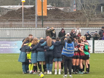 The AFC Bournemouth women in a huddle after their game.