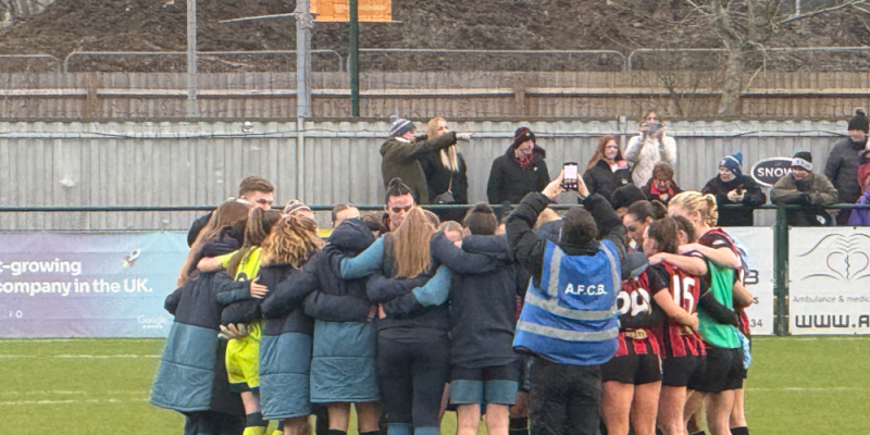 The AFC Bournemouth women in a huddle after their game.