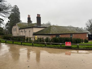 photo of a pink building along with a small redbrick one