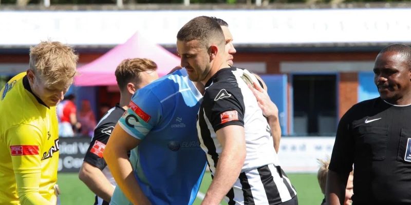 Dorchester Town player hugging another player.