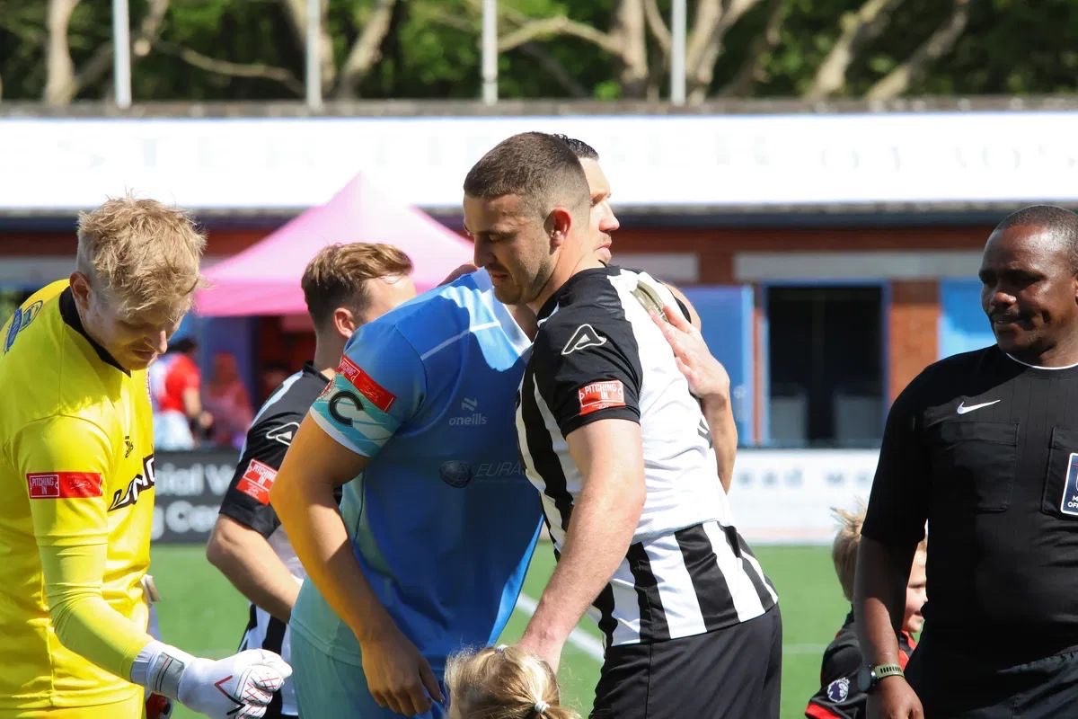Dorchester Town player hugging another player.