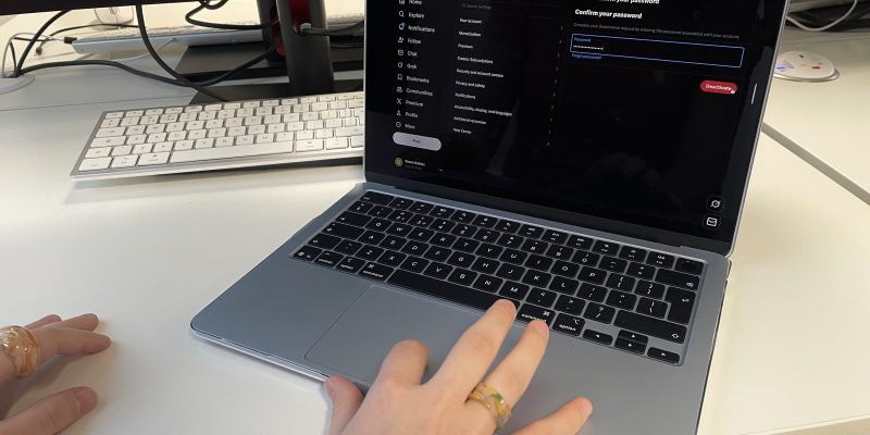 woman on her laptop, deactivating her X account.