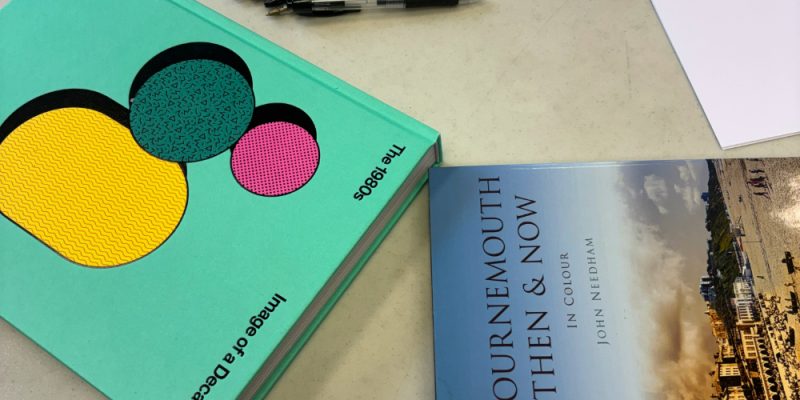 books on a table along with pens and paper