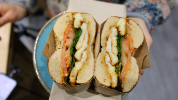 A bagel cut in half showing the colourful cross section.