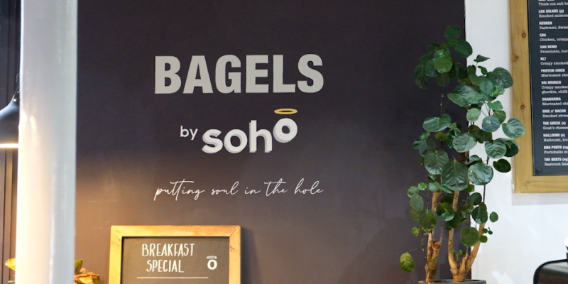 Board that says bagels by soho.