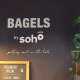 Board that says bagels by soho.
