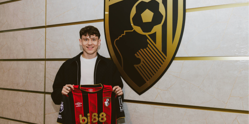 Alex Toth holds up a Bournemouth shirt