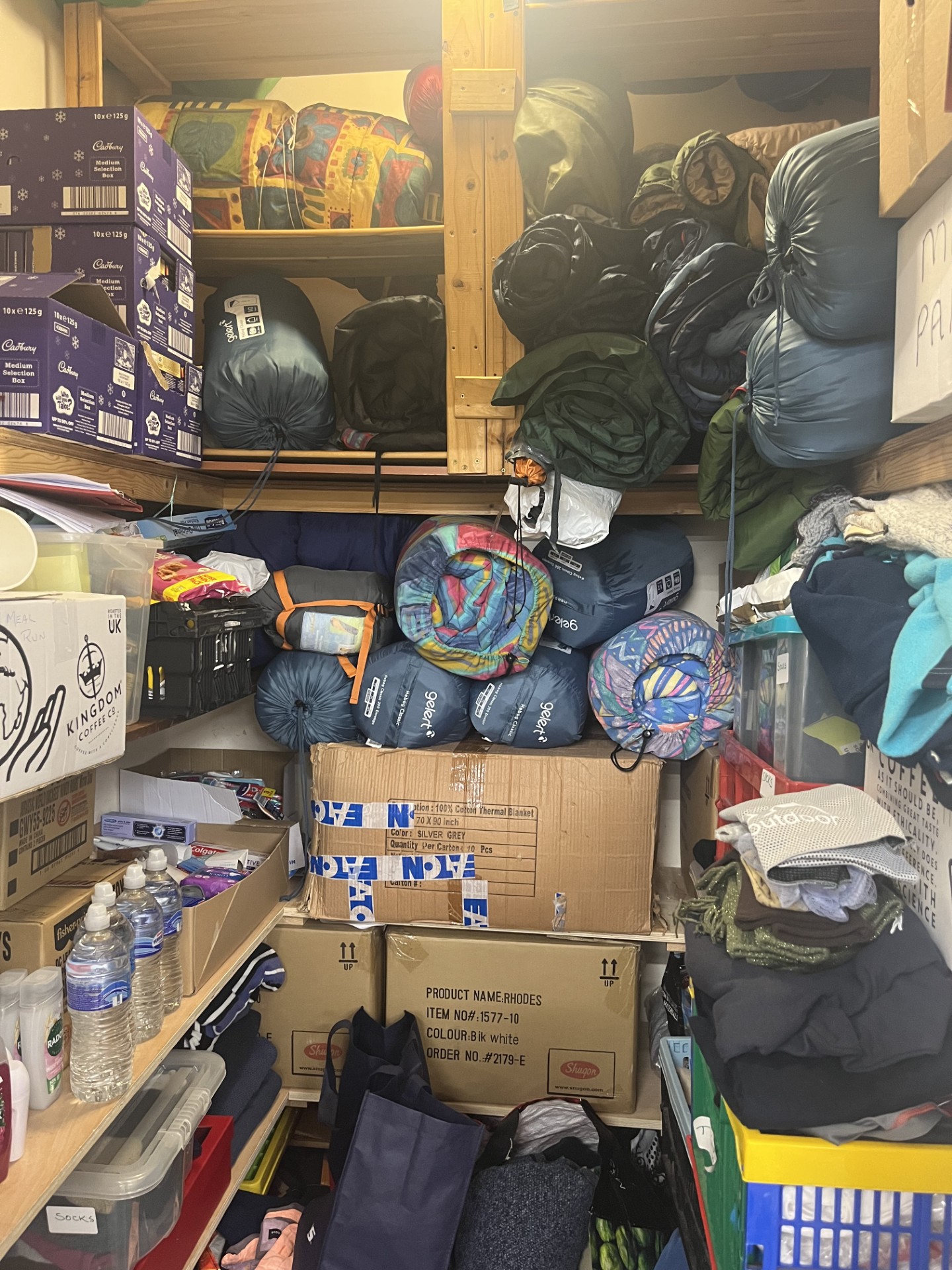 A cupboard with sleeping bags, blankets and spare clothes 