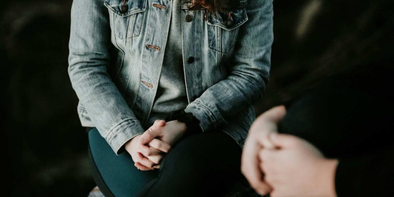 woman sits in therapy session