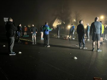 group of men in workout gear stretching