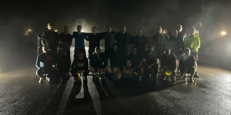 group of men in running gear on a dark foggy morning