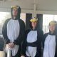three people dressed as penguins